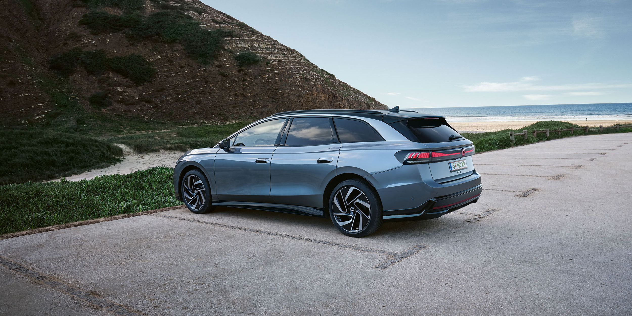 Seiten- und Heckansicht eines grau-blauen VW ID.7 Tourer
